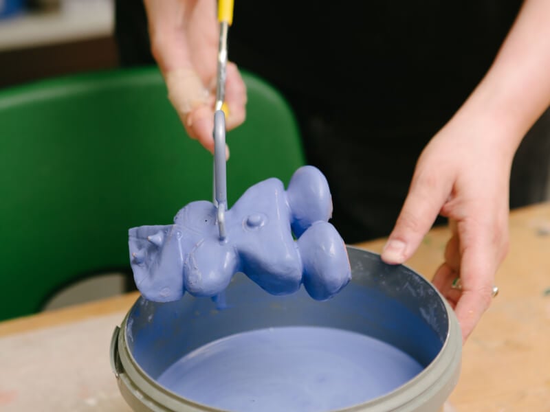A ceramic piece has been dipped in a blue glaze